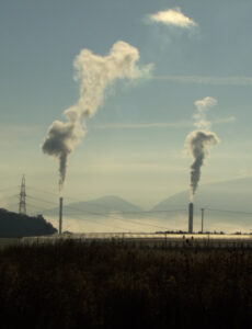 Steam from factory chimneys.